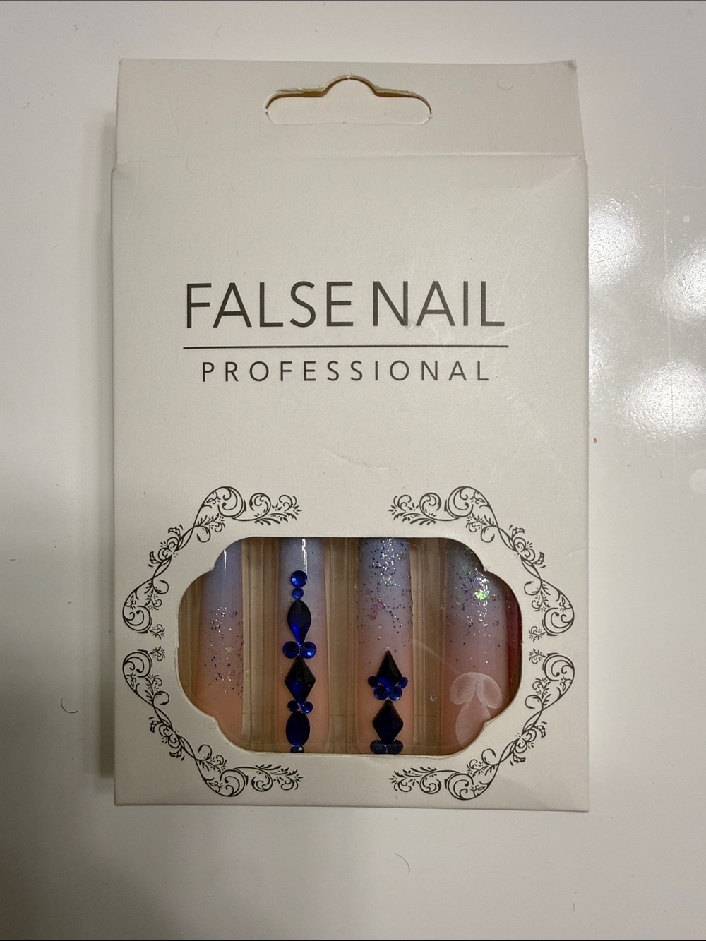 Professional Pink False Nails with Blue Rhinestone Accents -